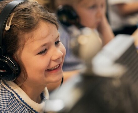 Hillside pupil listening to music on headphones