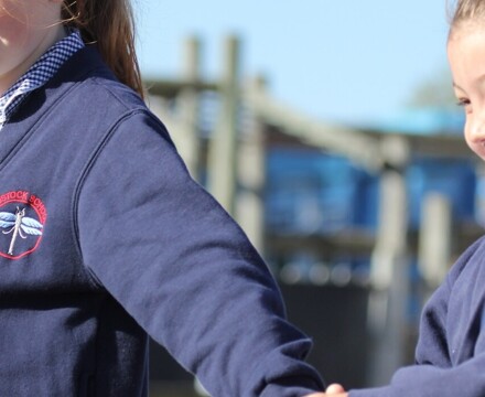 Radstock pupils holding hands outside